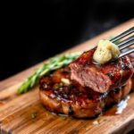 Juicy garlic butter steak bites sizzling in a pan, golden brown and herb-sprinkled