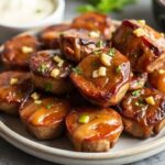 Juicy Steak Bites glazed in garlic butter on a rustic plate.